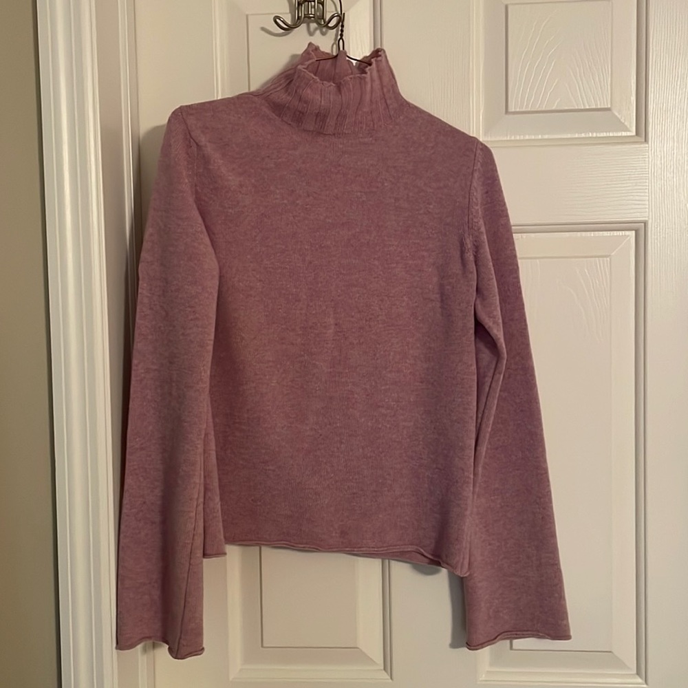 Merino wool sweater with bell sleeves and turtle neck.
